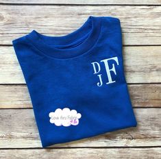 "These monogrammed t-shirts are made of a comfortable cotton fabric, making a casual, yet stylish, addition to the wardrobe of any boy. I offer boys t-shirts using four different styles of fonts. Shirts ordered from this listing will be monogrammed using a stacked font as shown in the listing picture. The order of the letters will be FIRST NAME as the top, small letter, MIDDLE NAME as the bottom small letter, and LAST NAME as the large letter. IMPORTANT: When placing your order please provide th Family Matching Blue Pre-shrunk Shirt, Personalized Blue Short Sleeve Tops, Blue Cotton Family Matching T-shirt, Blue Pre-shrunk Family Matching Shirt, Family Matching Personalized Blue T-shirt, Blue Crew Neck Shirt With Name Print, Blue Monogram Cotton Tops, Blue Cotton Tops With Name Print, Blue Cotton Top With Name Print