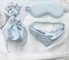 two satin sleep masks, one with a bow and the other with a pearl beaded necklace