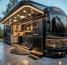 an rv is lit up at night with its lights on