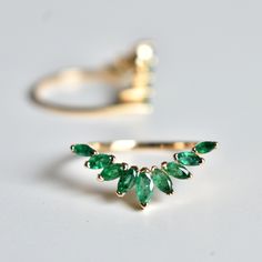 "Pop of green Emeralds in this sunburst ring enhancers are a great addition to your engagement and add sparkle, this wrap ring features marquise cut natural emeralds and is handcrafted in 14k solid gold. It adds the right amount of royal and drama to your classic solitaire engagement ring. A perfect anniversary gift! DETAILS FOR SINGLE BAND: * Gemstone : Natural Green Emeralds * Emerald Wt. : ~0.75 Ct * Gold - 14kt, ~2.5 gm solid gold If you like this ring, please press \"Pin it\" button on the Emerald Wrap Ring, Emerald Ring Leaves, Emerald Enhancer Ring, Emerald Engagement Ring Nature, Emerald Green Wedding Band With Engagement Ring, Green Emerald Engagement Ring With Band, Emerald Leaf Ring, Green Wedding Band Women, Emerald Gold Rings