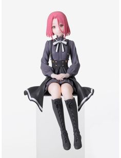 a figurine sitting on top of a white box with pink hair and black boots