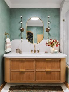 a bathroom with two sinks and a large mirror on the wall above it's counter