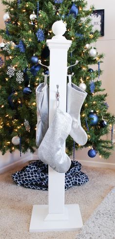 a christmas tree with stockings hanging from it