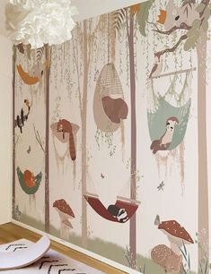 the wallpaper in this room is decorated with woodland animals and trees, including mushrooms