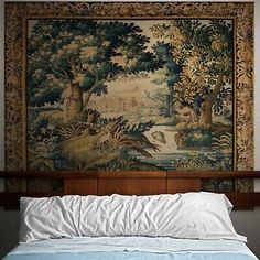 a large tapestry hanging above a bed in a room with wooden headboard and foot board