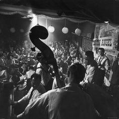 an old black and white photo of a band playing in front of a large crowd