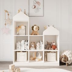 a white book shelf filled with books and toys