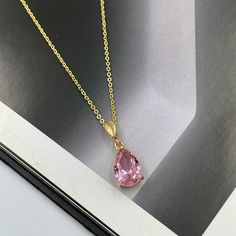 "Soft Pink Crystal Charm Necklace, Sparkly Pink Teardrop Pendant Necklace, Pink Charm Necklace, Gold Layering Necklace, Pink Teardrop Charm. This pink crystal teardrop pendant necklace adds the finishing touch to any outfit. Perfect for yourself, your mom, best friend, bridal party, and more! The pendant frame and chain are made from anti-tarnish gold materials. Measurements: Necklace length is 15\" plus 2 inches extender chain for adjustment. Teardrop crystal is 13 mm x 9 mm Necklace made in a Pink Gem Necklace, Pink Pendant Necklace, Mom Best Friend, Pink Charm, Pink Tourmaline Ring, Pink Gem, Purple Necklace, Pink Necklace, Teardrop Necklace