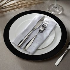 a table setting with silverware and napkins