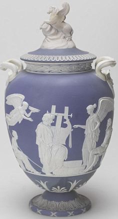 a blue and white vase with figures on it