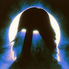 the silhouette of a person's head in front of an eyeball