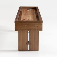 a wooden table topped with a glass top and two pieces of wood in the middle