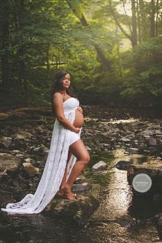 a pregnant woman is posing in the water for her family's photo shoot on instagram