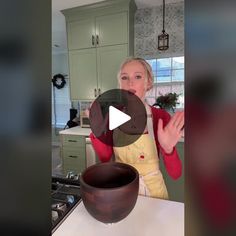 a woman standing in front of a bowl on top of a counter