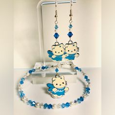 Beautifully Handcrafted Shades Of Blue Crystals And White Pearl Hello Kitty Bracelet And Earrings That. Earrings Are 2 1/4 Inches Long And Bracelet Is 7 1/2 Inches Long With A Sterling Silver Clasp. Cute Hypoallergenic Turquoise Jewelry, Cute Blue Hypoallergenic Jewelry, Hello Kitty Bracelet, Hello Kitty Jewelry, Blue Beaded Bracelets, Turquoise Cross, Beads Bracelet Design, Jewelry Beautiful, Handcrafted Bracelets