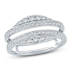 a white gold ring with three rows of diamonds on the sides and an open band