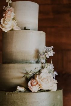 a three tiered cake with flowers on top