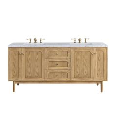 a double sink vanity with two faucets on top