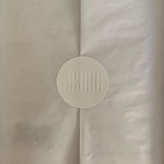 a white piece of paper with the word boo written on it and a round hole in the middle