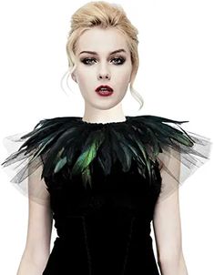 a woman in a black dress with green feathers on her neck and shoulders, standing against a white background