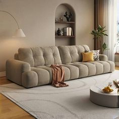 a living room filled with furniture and a white rug on top of a hard wood floor