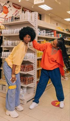 two women standing next to each other in a store