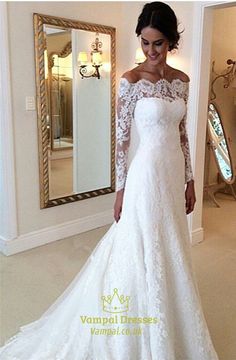 a woman in a white wedding dress posing for the camera with her hand on her hip