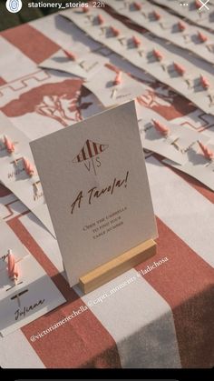 a table topped with lots of cards on top of a red and white checkered table cloth