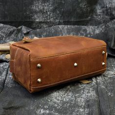 This leather toiletry bag is made of genuine cowhide leather, Every seam is reinforced and the zippers are heavy-duty, with strong zipper pulls that will last for years without breaking off or splitting in this dopp kit for men.     ITEM FEATURES  - 1 x Main Compartment - 1 x Interior Zipper Pocket - 2 x Slot Pockets - 1 x Back Zipper Pocket - 5 x Bottom Rivets - Genuine Leather & Durable - Side Handle Design      ITEM DETAILS  *Item Type: Toiletry Bag *Material: Crazy Horse Leather *Size: L26 *W11 *H15(CM) *Color: Brown /Dark Brown/ Black/ Wine Red *Closure Type: Zipper *Style: Vintage    CARE INSTRUCTIONS  * Our products are designed to last a lifetime  Natural Leather creams and waxes are the way to go! Avoid chemicals or sprays. I recommend.    WE OFTEN GET ASKED WHAT IS CRAZY HORSE? Men Day, Mini Cows, Leather Toiletry Bag, Real Leather Handbags, Leather Clutch Wallet, Bags For Men, Small Tote Bag, Dopp Kit, Genuine Leather Wallets