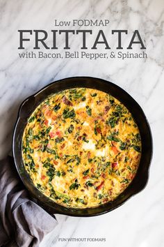 an omelet with bacon, bell pepper and spinach in a cast iron skillet