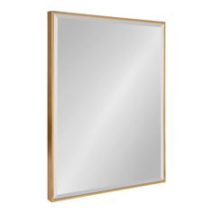 a gold framed mirror on a white wall with a light brown border around the edges