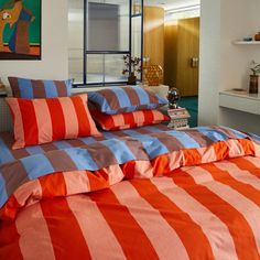 an orange and blue striped bed spread in a bedroom