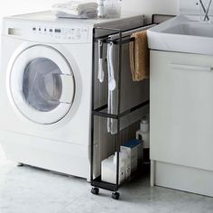 a white washer sitting next to a kitchen sink