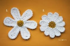 two crocheted white flowers with yellow centers