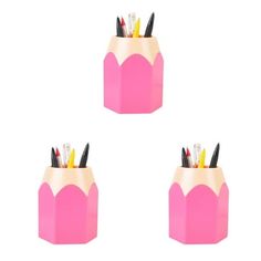 three pink pencil holders with pens in them