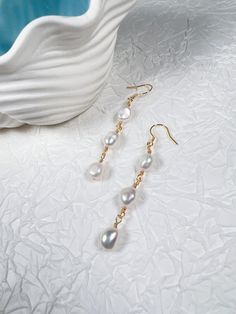 Add a touch of sophistication to your ensemble with these stunning pearl drop earrings. Featuring a cascading design of lustrous pearls, these earrings gracefully complement any bridal or evening look. Each pearl, is handpicked for its radiant glow and smooth surface, creating an elegant flow that enhances your natural beauty. Specifications: Total Length: 6 cm Pearl Size: 8-9 mm in diameter Style: Ideal for weddings, formal events, or as a special gift Features: Handcrafted: Each pair is carefu Dainty Style, Simple Packaging, Pearl Dangle Earrings, Box Making, Earrings Dainty, Pearl Earrings Dangle, Pearl Size, Pearl Drop Earrings, Pearl Drop