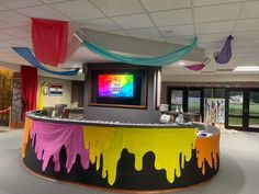 an office decorated with colorful streamers and drapes