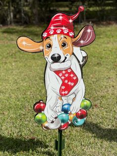 a dog with a red bandana on it's head is standing in the grass