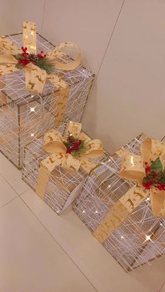 two boxes with bows and lights on them