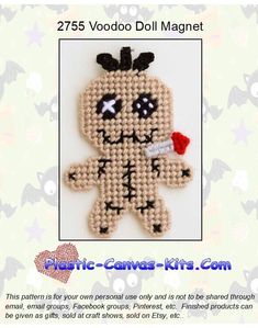 a cross stitch voodoo doll with a needle on it's back