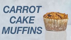 a muffin sitting on top of a table next to the words carrot cake muffins