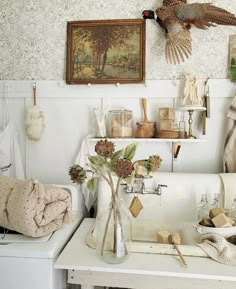 a kitchen with a white stove top oven sitting next to a wall covered in pictures