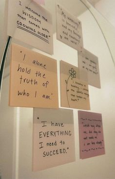 sticky notes attached to a refrigerator door with magnets on the wall and writing on them