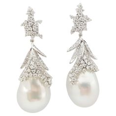 South Sea Pearl with Diamond 0.80 carats Earrings set in 18 Karat White Gold Settings Width: 1.5 cm Length: 8.0 cm Total Weight: 19.36 grams South Sea Pearl: 15.3 mm "We first opened doors in 1980 when it was then situated in the vicinity of the Victory Monument; a small and modest storefront with a couple of counters. From its humble beginnings to where it stands today, our company has proven its abilities as a jeweler. Since the beginning, we have been supplying fine quality pieces to dealers, Luxury Hallmarked Pear-shaped Diamond Earrings, Luxury Pear-shaped Diamond White Diamond Earrings, Luxury Pear-shaped Diamond White Earrings, Pear-shaped Diamond Earrings For Formal Events, Luxury Pear-shaped Diamond Earrings For Evening, Luxury Diamond Pearl Earrings For Formal Occasions, Luxury White Gold Bridal Earrings With Pave Setting, Luxury Diamond Pearl Earrings For Formal Events, Formal Pear-shaped Pave Setting Earrings