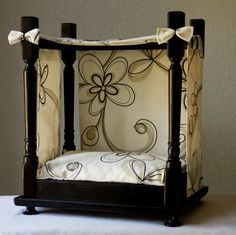 a baby crib that has been decorated with black and white flowers on the sides