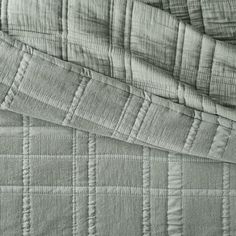 the texture of an unmade bed is shown in this black and white photo,