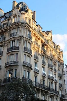 a tall building with many balconies and windows