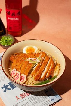 a bowl filled with rice, meat and veggies next to a bottle of wine