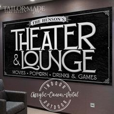 the theater and lounge sign is displayed in front of a gray wall with black lettering