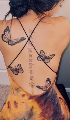 the back of a woman's neck with butterflies on her upper and lower back